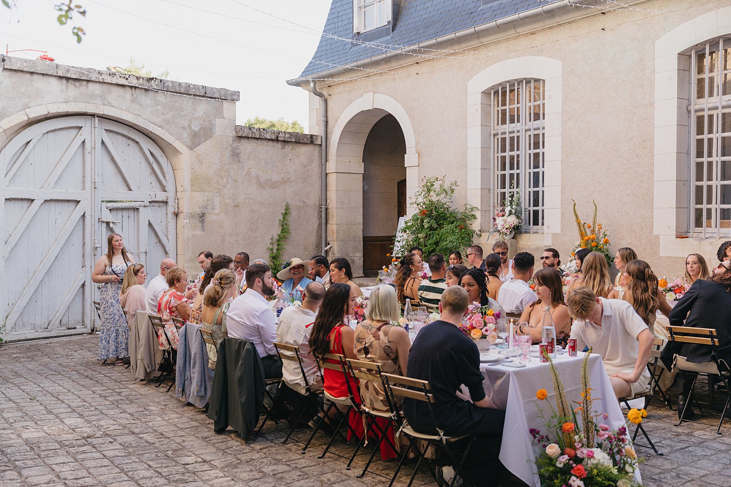 laughing guests in courtyard at Château de Thauvenay